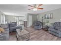 Spacious living room featuring hardwood floors, comfortable seating, and a ceiling fan at 205 Twin Oaks Dr, Angier, NC 27501