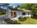 Inviting white brick home with a charming front entrance and a lush green lawn at 207 N Aiken St, Fuquay Varina, NC 27526