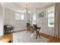 Well-lit office boasts hardwood floors, white wainscoting, and neutral decor at 208 Vervain Way, Holly Springs, NC 27540