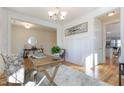 Bright office space with hardwood floors, white wainscoting, modern lighting and a decorative rug at 208 Vervain Way, Holly Springs, NC 27540