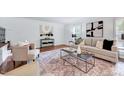 Bright living room with hardwood floors, stylish furniture, and modern art at 212 Ronaldsby Dr, Cary, NC 27511