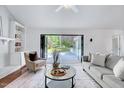 Cozy living room with fireplace and french doors leading to outdoor deck at 212 Ronaldsby Dr, Cary, NC 27511
