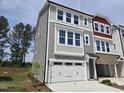 Charming three-story townhome with two car garage, neutral siding and an abundance of windows at 2201 Lambert Rd # 66, Cary, NC 27519