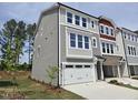 Charming three-story townhome with two car garage, neutral siding and an abundance of windows at 2201 Lambert Rd # 66, Cary, NC 27519