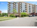 Modern multi-story condo building featuring a brick and glass exterior with street-level parking at 2202 Environ Way # Bldg 2000, Chapel Hill, NC 27517