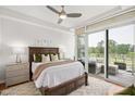Serene main bedroom features a large bed and private balcony with outdoor seating and scenic views at 2202 Environ Way # Bldg 2000, Chapel Hill, NC 27517
