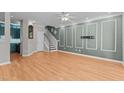 Bright, spacious living room with contemporary trim, hardwood floors and a ceiling fan at 2210 Raven Rd # 105, Raleigh, NC 27614