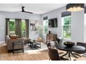 Sunlit living room featuring modern furnishings, neutral tones, wood floors and outdoor view at 2325 Sheffield Rd # 102, Raleigh, NC 27610