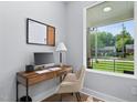 Bright home office with a modern desk, decor, and a window overlooking the front yard at 2325 Sheffield Rd # 102, Raleigh, NC 27610