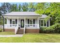 Inviting home with a covered front porch and classic architectural details at 2402 Cynthia Dr, Durham, NC 27704