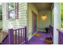 Inviting porch with vibrant purple accents and colorful flowers near the front door at 244 Sweet Bay Pl, Carrboro, NC 27510