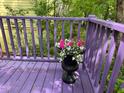 Cozy porch with purple painted railings, wood flooring, and flower decorations at 244 Sweet Bay Pl, Carrboro, NC 27510