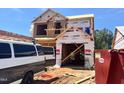 Two-story home under construction with workers installing exterior sheathing at 251 Bluejay St, Clayton, NC 27520