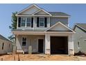 New two-story home featuring gray siding, black shutters, and an attached one-car garage at 251 Bluejay St, Clayton, NC 27520