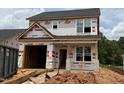 Two-story home under construction, displaying the exterior elevation, windows, and the initial stages of the building process at 256 Bluejay St, Clayton, NC 27520