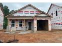 New construction home with a garage and covered entrance is set in a community at 257 Bluejay St, Clayton, NC 27520