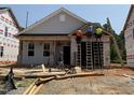 New construction home featuring gray siding, black roof, and front porch in a residential neighborhood at 262 Bluejay St, Clayton, NC 27520
