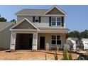 New two-story home with a two-car garage featuring a neutral color scheme at 263 Bluejay St, Clayton, NC 27520