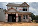 Two-story new construction home featuring a garage and covered porch, awaiting its finishing touches at 263 Bluejay St, Clayton, NC 27520