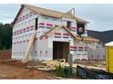 Exterior framing of a new two-story home showing the house wrap and roofline under construction at 268 Bluejay St, Clayton, NC 27520