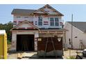New two-story home under construction with visible house wrap and two-car garage at 268 Bluejay St, Clayton, NC 27520