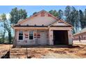 New construction home featuring a covered entrance and an attached two car garage at 31 Goldenrod Loop, Clayton, NC 27520