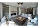 Spacious living room with fireplace, built-in shelving, modern furniture and wood flooring at 31 Goldenrod Loop, Clayton, NC 27520