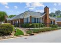 Charming brick home with manicured landscaping, mature trees, and well-maintained lawn creating an inviting curb appeal at 312 Troon Village Ln, Cary, NC 27511