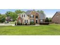 Charming two-story home with a lush green lawn, mature trees, and a classic architectural design at 321 Nortwick Rd, Rolesville, NC 27571