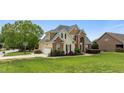 Attractive two-story home featuring a side-entry garage, well-kept lawn, and mature trees at 321 Nortwick Rd, Rolesville, NC 27571