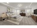 Spacious main bedroom with tray ceiling, carpet, and abundant natural light at 3231 Pelican Ln, Durham, NC 27703