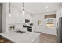 Modern kitchen features granite countertops, stainless steel appliances, and a subway tile backsplash at 3233 Pelican Ln, Durham, NC 27703