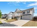 Inviting two-story home with a spacious driveway, a front porch, and manicured lawn at 3422 Norway Spruce Rd, Raleigh, NC 27616
