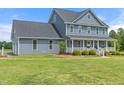 Attractive two-story home with a covered front porch and lush green lawn, showcasing curb appeal at 3805 Euliss Rd, Burlington, NC 27215