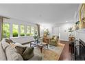 Bright and airy living room with large windows, comfortable seating, and a fireplace at 3915 Nottaway Rd, Durham, NC 27707