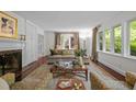 Spacious living room with stylish furniture, fireplace, and windows to the outside at 3915 Nottaway Rd, Durham, NC 27707