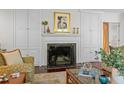 Elegant living room with fireplace, built-in cabinets, and stylish decor at 3915 Nottaway Rd, Durham, NC 27707