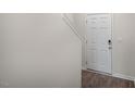 A bright entryway features hard surface flooring, a white interior door, and access to the stairs at 400 Ember St, Sanford, NC 27330
