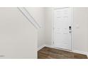 Welcoming entryway featuring durable wood-look flooring and a stylish white front door at 404 Ember St, Sanford, NC 27330