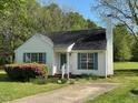 Classic home featuring a well-manicured lawn and beautiful flowering shrubbery at 409 Vista Springs Cir, Holly Springs, NC 27540