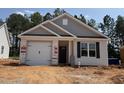 New construction home featuring a white garage door, brown front door, and black shutters at 41 Goldenrod Loop, Clayton, NC 27520