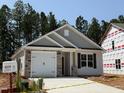 Charming one-story home featuring a stone-accented garage, neutral siding, and a welcoming front entrance at 41 Goldenrod Loop, Clayton, NC 27520