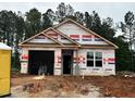 New construction home featuring an attached garage and situated on a wooded lot at 41 Goldenrod Loop, Clayton, NC 27520