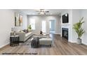 Bright living room features hardwood floors, a fireplace, and a ceiling fan for comfortable living at 41 Goldenrod Loop, Clayton, NC 27520