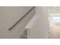 Staircase leading to a room, featuring neutral walls, and a handrail at 420 Ember St, Sanford, NC 27330