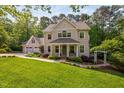 Charming two-story home with a welcoming front porch, well-manicured lawn, and a three-car garage at 4405 New Brighton Dr, Apex, NC 27539