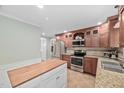 Well-appointed kitchen with stainless steel appliances, granite countertops, and custom wood cabinetry at 4405 New Brighton Dr, Apex, NC 27539