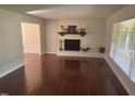 Bright living room with hardwood floors and a fireplace, creating a warm and inviting atmosphere at 5026 Gatewood Drive Dr, Durham, NC 27712