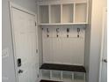 Convenient mud room with built-in storage, bench, and coat hooks, providing functionality at 5026 Gatewood Drive Dr, Durham, NC 27712
