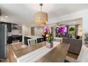 Dining room with decorative chandelier, and view into the living room and updated kitchen at 5505 Knollwood Rd, Raleigh, NC 27609